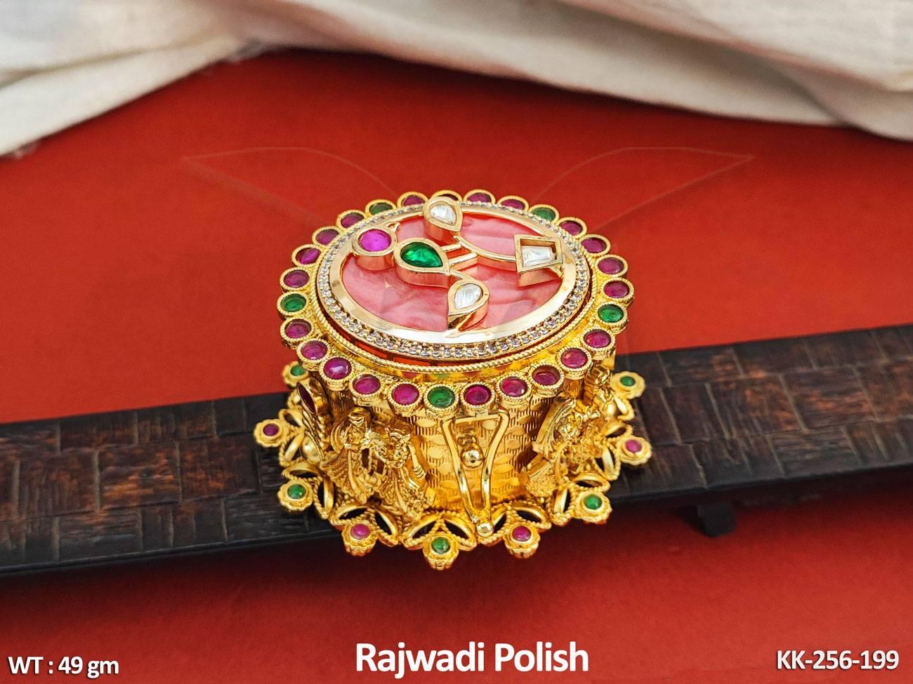 An intricately designed open kumkum and sindoor box showcasing vibrant red powders, placed on a colorful fabric backdrop, highlighting cultural significance and beauty.